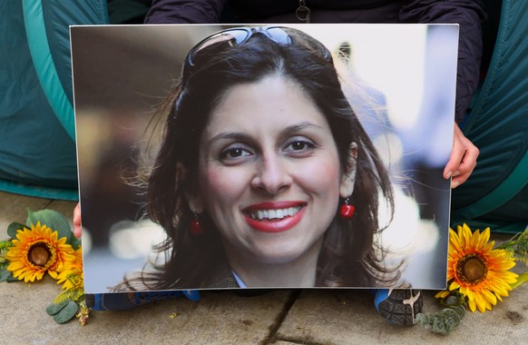 epa09828542 (FILE) Richard Ratcliffe (not pictured) holds a photograph of his wife, Nazanin Zaghari-Ratcliffe, outside the Foreign Office in London, Britain, 26 October 2021 (reissued 16 March 2022).  ...