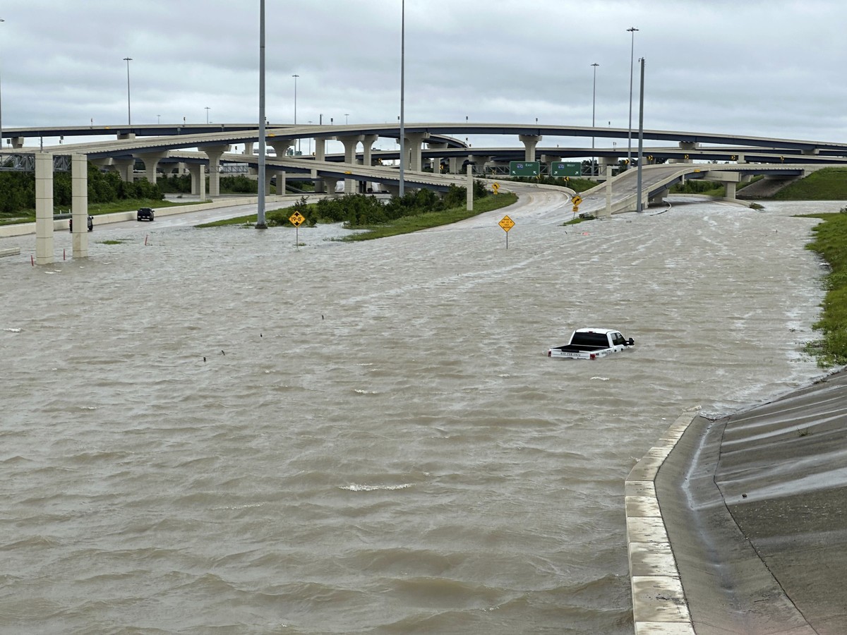 A vehicle is stranded in high waters on a flooded highway in Houston, on Monday, July 8, 2024, after Beryl came ashore in Texas as a hurricane and dumped heavy rains along the coast. (AP Photo/Juan A. ...