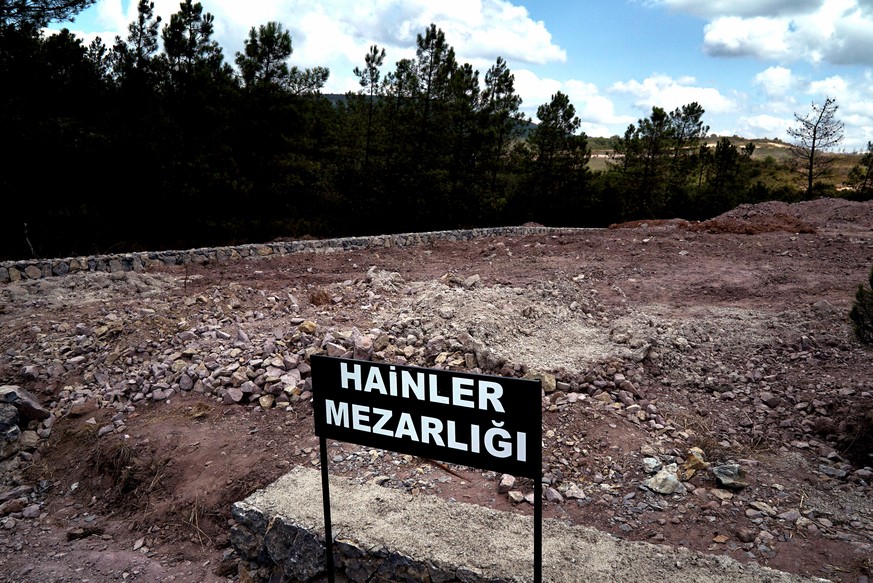 CORRECTS PHOTOGRAPHER&#039;S NAME - A sign reading in Turkish &quot;Traitors&#039; Cemetery&quot; is seen in front of unmarked graves, built specifically to hold the bodies of coup plotters who died i ...