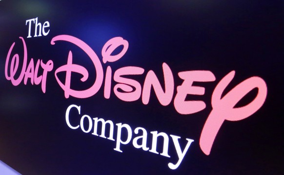 FILE - In this Aug. 7, 2017, file photo, The Walt Disney Co. logo appears on a screen above the floor of the New York Stock Exchange. The Walt Disney Co. returned to a quarterly profit as it once agai ...