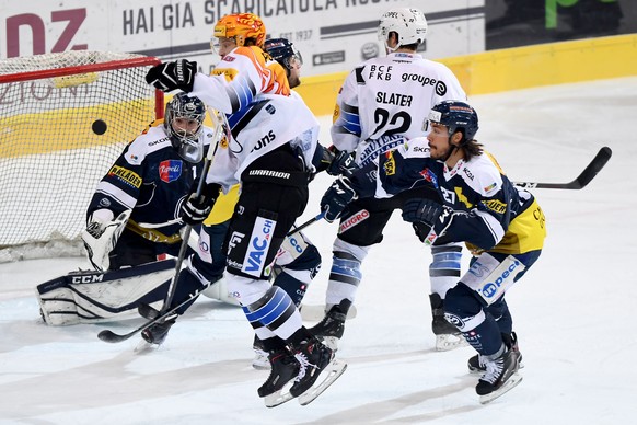 from left Ambri's goalkeeper Benjamin Conz,Gotteron’s player Julien Sprunger, Gotteron’s player Jim Slater and Ambri's player Samuel Guerra, during the preliminary round game of National League Swiss  ...