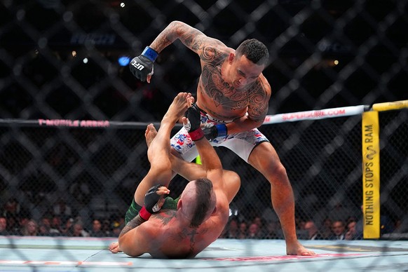 LAS VEGAS, NEVADA - JULY 11: Max Holloway punches Conor McGregor of Ireland in a welterweight fight during the UFC 329 event at T-Mobile Arena on July 11, 2026 in Las Vegas, Nevada. (Photo by Cooper N ...