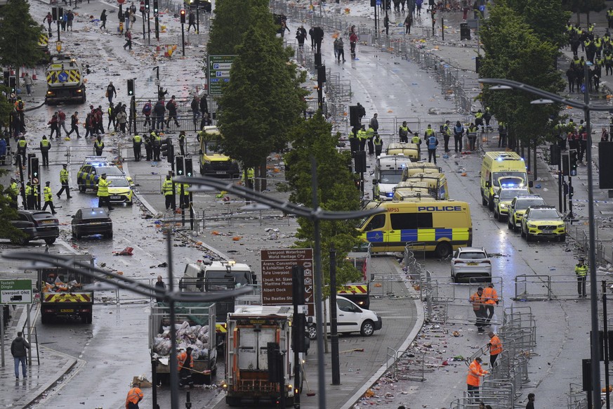 Police and emergency personnel deal with a road traffic accident on Water Street near the Liver Building in Liverpool after a car collided with pedestrians during the Premier League winners parade, in ...