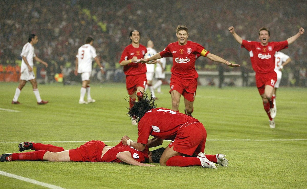 Liverpool's Xabi Alonso, left on the ground, is congratulated by teammates after scoring from a penalty rebound against AC Milan during the Champions League Final at The Ataturk Olympic Stadium,  ...