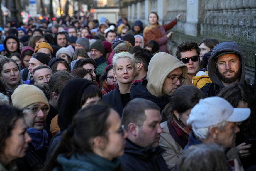 Yulia Navalnaya, center, widow of Alexey Navalny, stands in a queue with other voters at a polling station near the Russian embassy in Berlin, after noon local time, on Sunday, March 17, 2024. The Rus ...