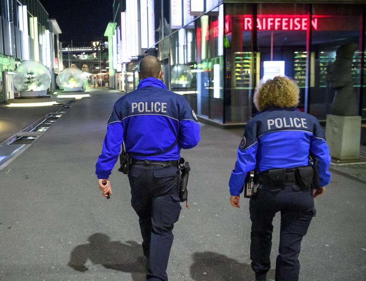 Lausanne's Police officers patrol to prevent the gathering of more than 5 people in the empty "Quartier du Flon" night district during the coronavirus disease (COVID-19) outbreak, late  ...