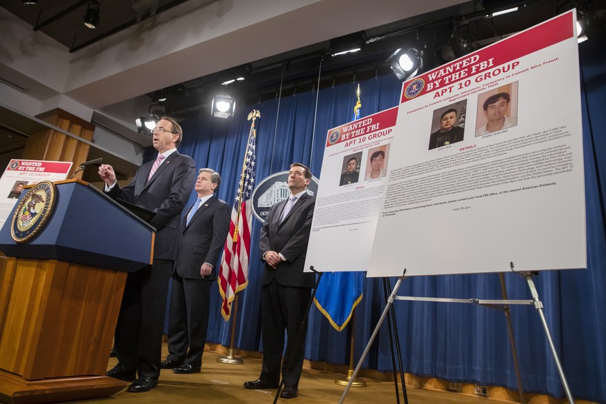 epaselect epa07242415 Deputy US Attorney General Rod Rosenstein (L) and FBI Director Christopher Wray (C) participate in a press conference at the Department of Justice in Washington, DC, USA, 20 Dece ...