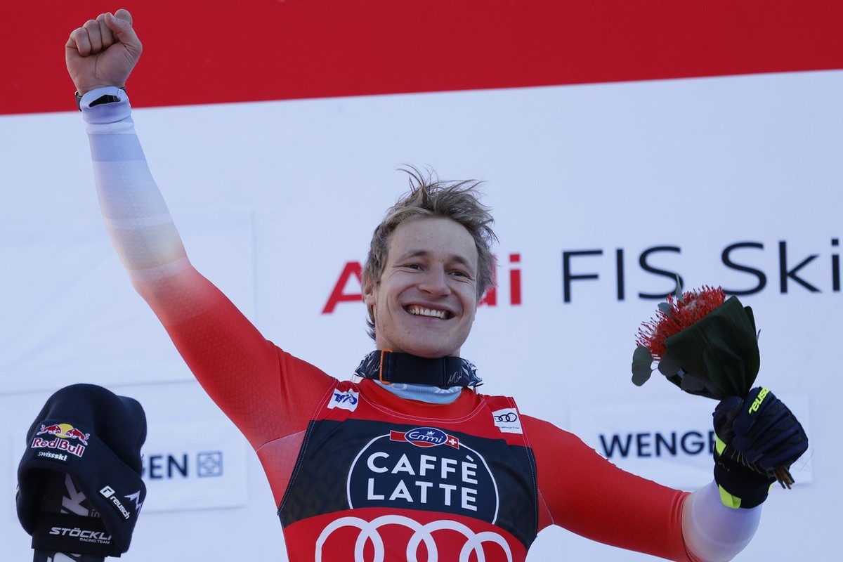 The winner Switzerland's Marco Odermatt celebrates after completing an alpine ski, men's World Cup downhill race, in Wengen, Switzerland, Saturday, Jan. 13, 2024. (AP Photo/Alessandro Trovat ...