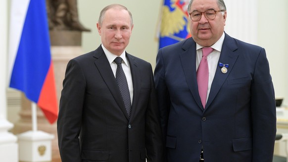 FILE - Russian President Vladimir Putin, left, poses for a photo with USM Holdings founder, businessman Alisher Usmanov during an awarding ceremony in Moscow's Kremlin, Russia, Jan. 26, 2017. The Unit ...