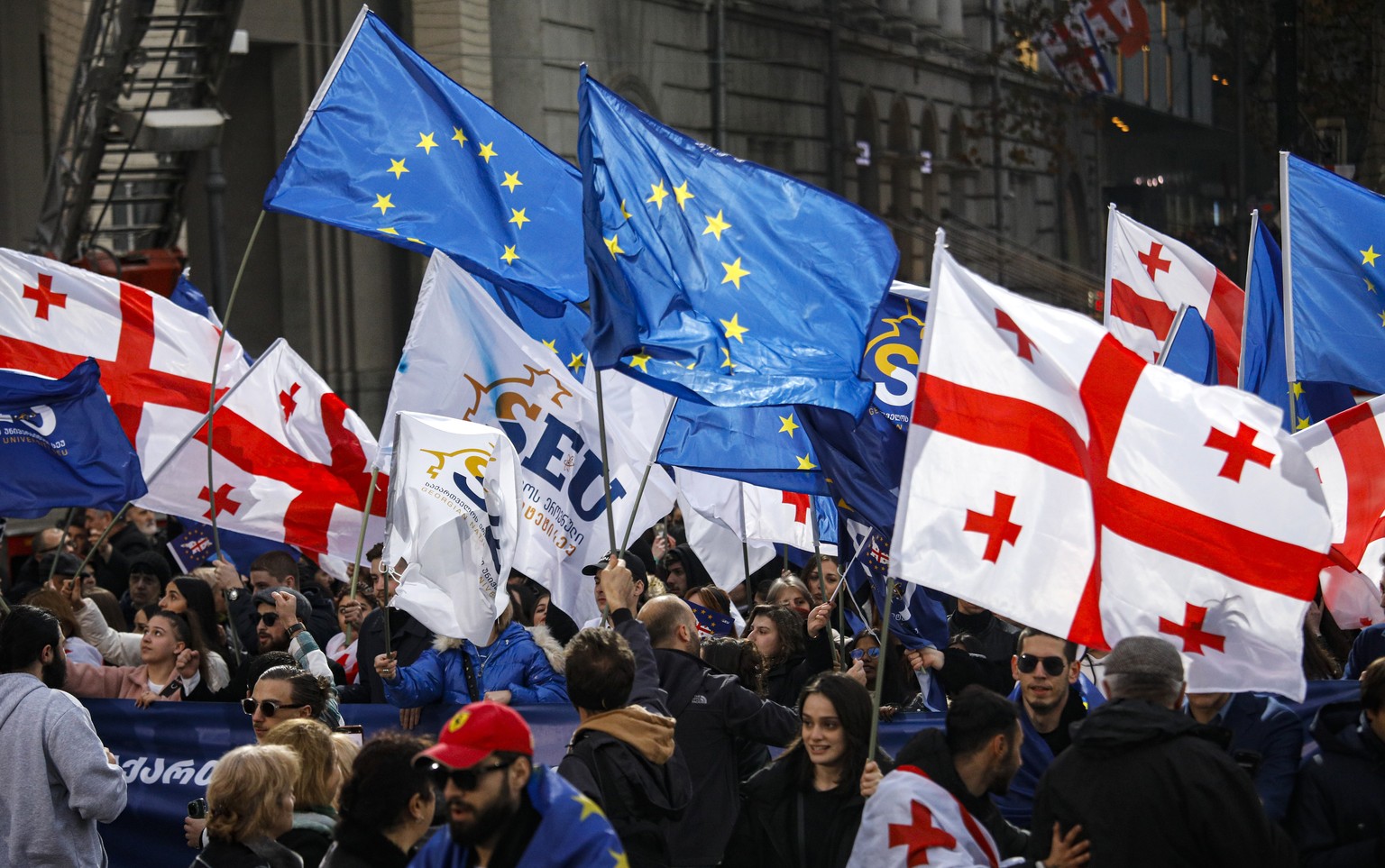 epa11031259 People celebrate during a rally after Georgia was granted the status of an official candidate for accession to the European Union, in downtown Tbilisi, Georgia, 15 December 2023. The Counc ...