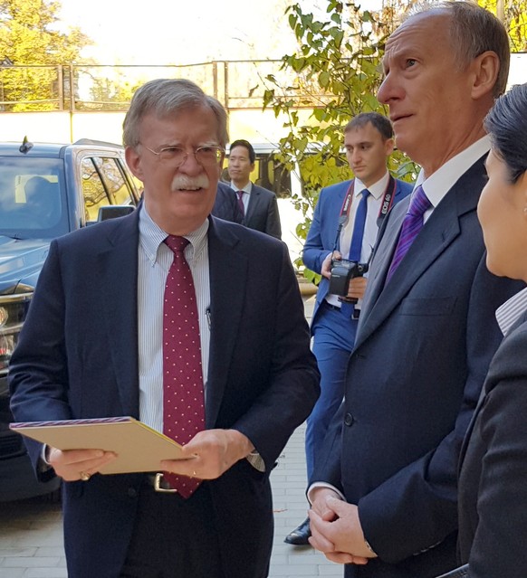 epa07110853 A handout photo made available by the Russian Security Council press service shows Security Council Secretary Nikolai Patrushev (2-R) receiving US National Security Adviser John Bolton (L) ...