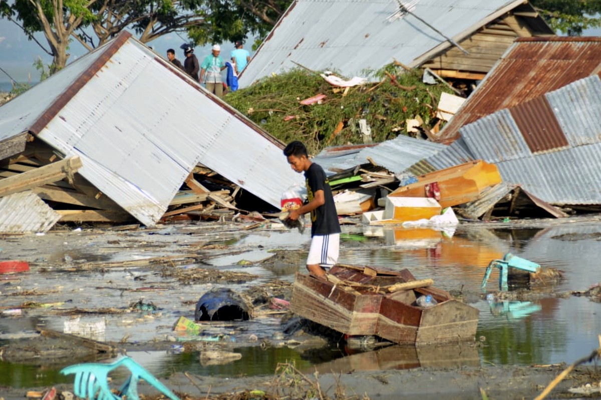 A man surveys the damage caused by earthquake and tsunami in Palu, Central Sulawesi, Indonesia, Saturday, Sept. 29, 2018. The powerful earthquake rocked the Indonesian island of Sulawesi on Friday, tr ...