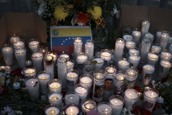 Candles ara place on an altar during a vigil for the victims of a fire at an immigration detention center that killed dozens in Ciudad Juarez, Mexico, Tuesday, March 28, 2023. According to Mexican Pre ...