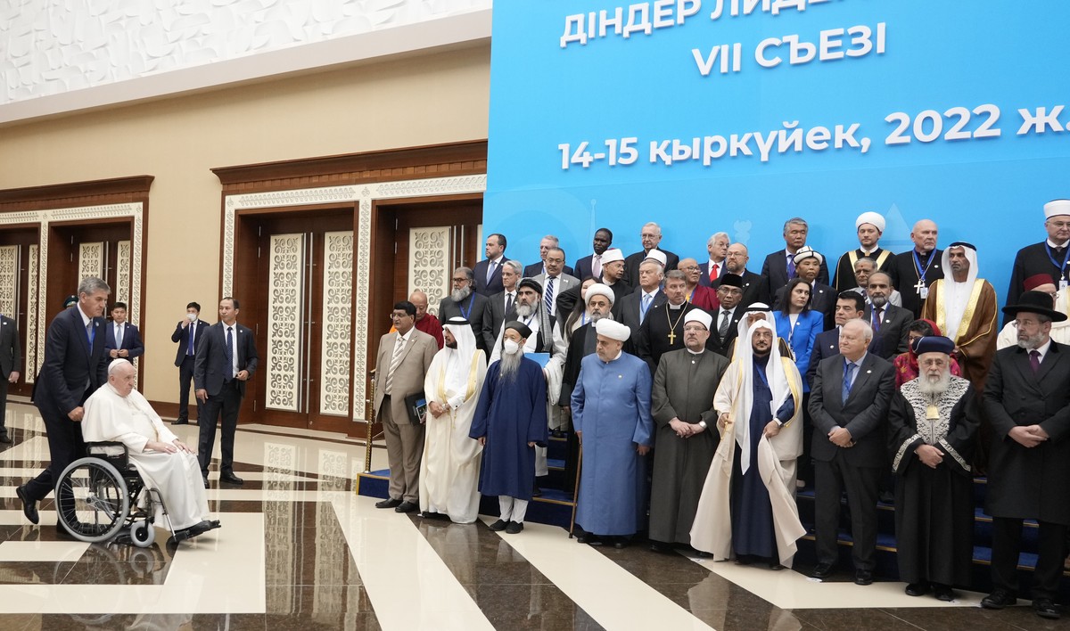 Pope Francis arrives for a family photo in a wheelchair at the '7th Congress of Leaders of World and Traditional Religions, in Nur-Sultan, Kazakhstan, Wednesday, Sep. 14, 2022. Against the backdr ...