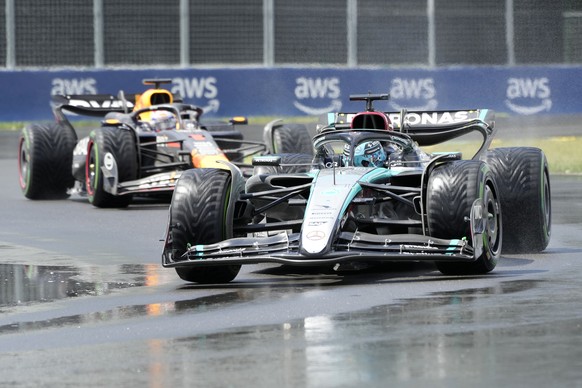 Mercedes driver George Russell, right, of the United Kingdom, leads as Red Bull driver Max Verstappen, of the Netherlands, follows during the Canadian Grand Prix Formula 1 car race, in Montreal, Sunda ...