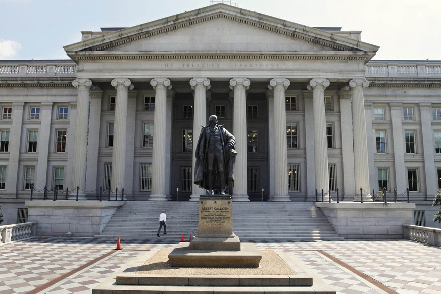 FILE- In this Monday, Aug. 8, 2011, file photo, a statue of former Treasury Secretary Albert Gallatin stands guard outside the Treasury Building in Washington. The U.S. budget deficit grew by nearly $ ...