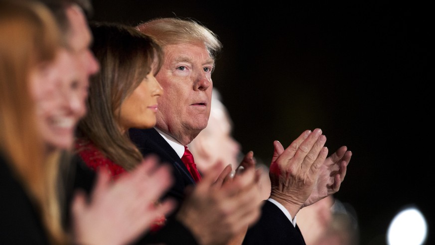 President Donald Trump and first lady Melania Trump applaud as they watch performances during the lighting ceremony for the 2017 National Christmas Tree on the Ellipse near the White House in Washingt ...