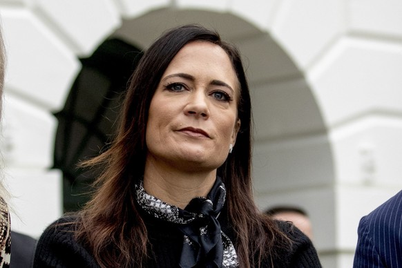 FILE- In this Oct. 3, 2019 file photo, White House press secretary Stephanie Grisham listens as President Donald Trump speaks to the media on the South Lawn of the White House in Washington. Grisham,  ...