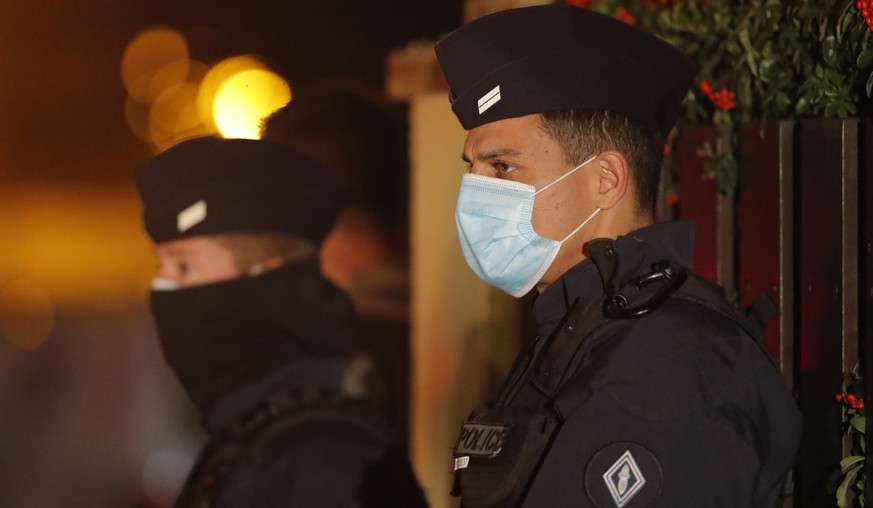 French police officers stand outside a high school after a history teacher who opened a discussion with students on caricatures of Islam&#039;s Prophet Muhammad was beheaded, Friday, Oct. 16, 2020 in  ...