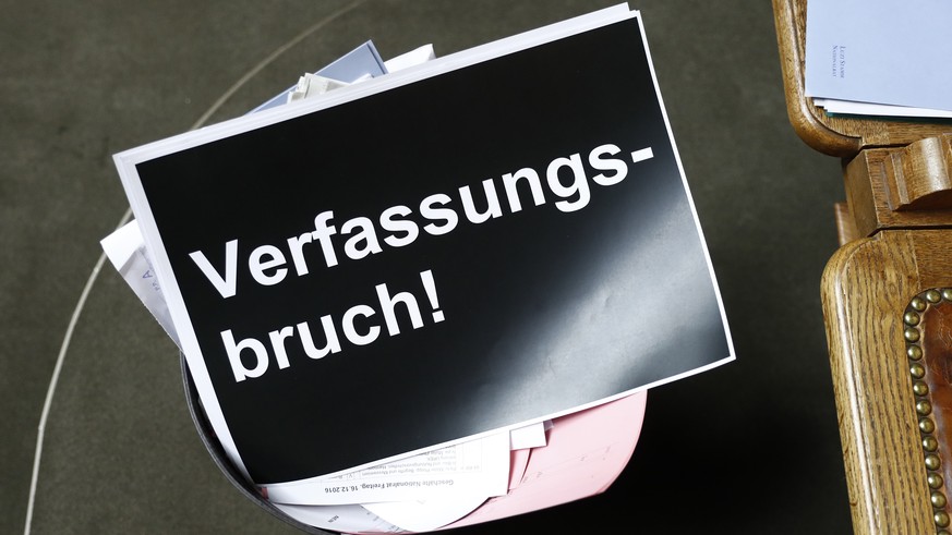 Ein Plakat mit der Aufschrift &quot;Verfassungsbruch&quot; liegt in einem Papierkorb, nach der Schlussabstimmung ueber die Umsetzung der Masseneinwanderungsinitiative im Nationalrat, waehrend der Wint ...