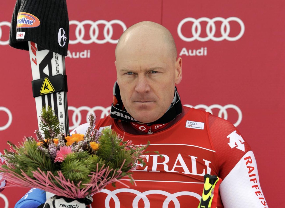 Switzerland's Didier Cuche stands on the podium after winning an alpine ski, men's World Cup super-G race in Kvitfjell, Norway, Sunday, March 13, 2011. (AP Photo/Alessandro Trovati)