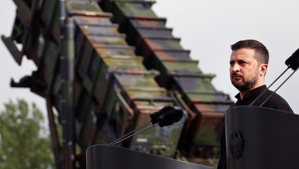 epa11404625 President of Ukraine Volodymyr Zelensky stands in front of a 'Patriot' anti-aircraft missile system during his visit to a military training area in Germany, 11 June 2024. Ukraini ...
