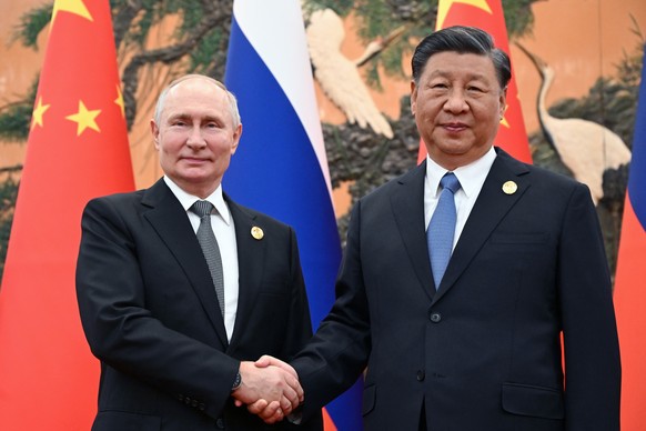 Chinese President Xi Jinping, right, and Russian President Vladimir Putin pose for a photo prior to their talks on the sidelines of the Belt and Road Forum in Beijing, China, on Wednesday, Oct. 18, 20 ...
