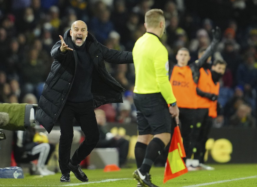 Manchester City&#039;s head coach Pep Guardiola reacts during the English Premier League soccer match between Leeds United and Manchester City, at Elland Road Stadium in Leeds, England, Wednesday, Dec ...