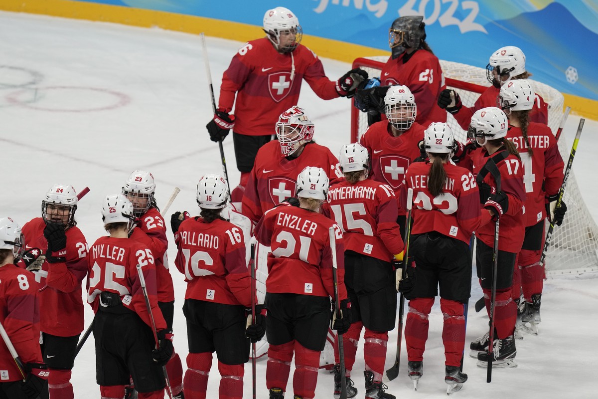 Team Switzerland players gather after a 10-3 loss to Canada in a women's semifinal hockey game at the 2022 Winter Olympics, Monday, Feb. 14, 2022, in Beijing. (AP Photo/Petr David Josek)