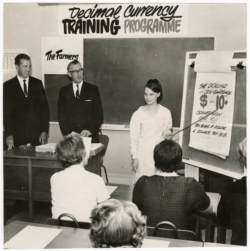 Miss J. A. Roach giving decimal currency training at the New Zealand Farmers&#039; Co-operative association. To her left is Mr G. Martson, chairman of the association&#039;s decimal currency committee ...