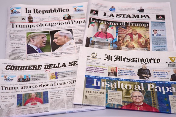 This picture, taken Tuesday, April 14, 2026, shows the front pages of some Italian newspapers reporting on comments by U.S. President Donald Trump about Pope Leo XIV, with headlines using words such a ...