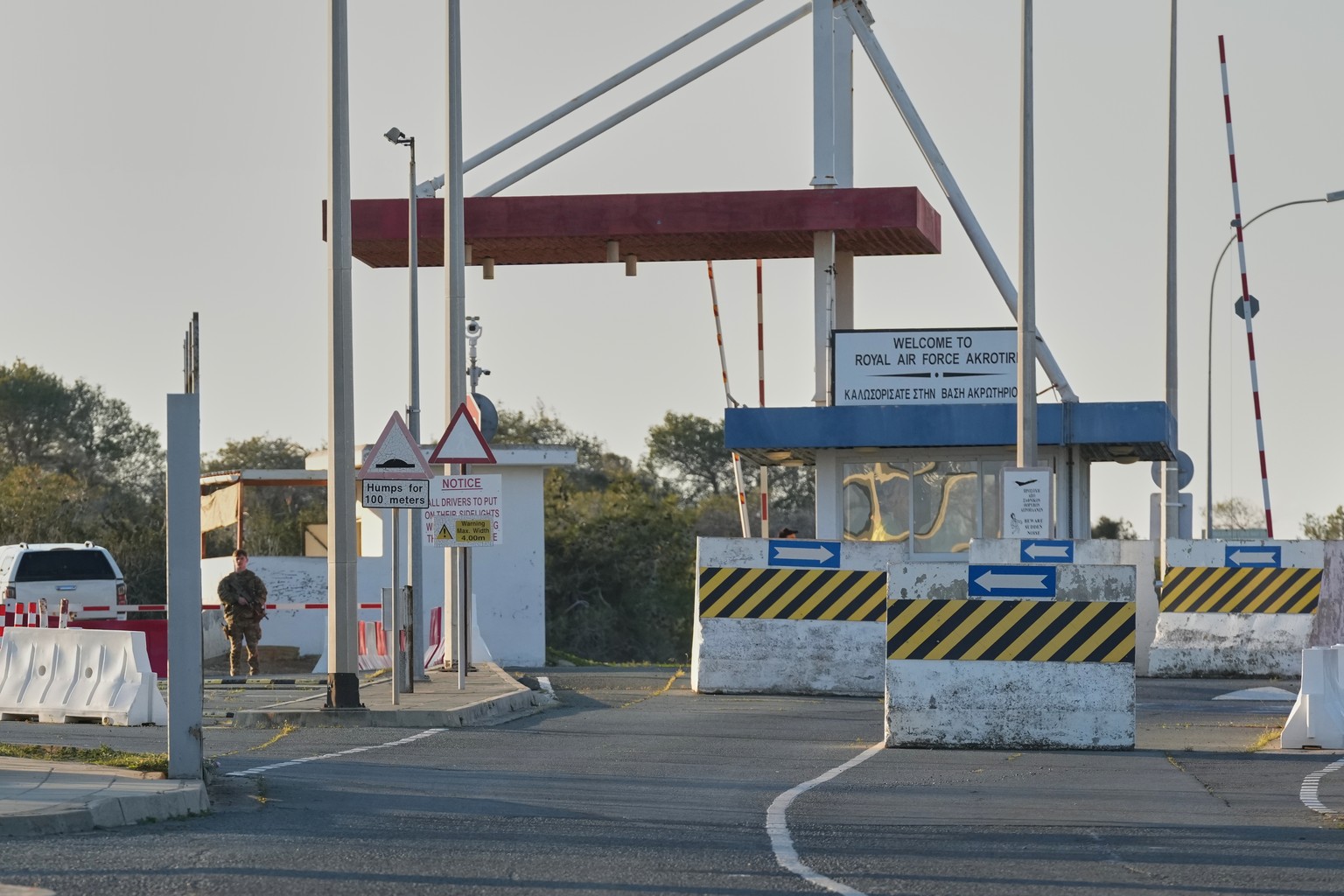 A British soldier stands guards at the main gate of the UK's RAF Akrotiri base after it was hit by a suspected drone strike early morning near Limassol, Cyprus, Monday, March 2, 2026. (AP Photo/P ...