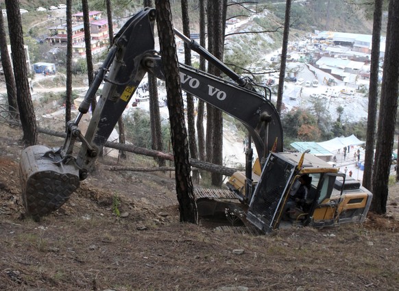 An earthmover makes a vertical drill at the top of a mountain where a tunnel collapsed in Uttarakhand state, India, Saturday, November 18, 2023. Forty workers were trapped in the collapsed road tunnel...