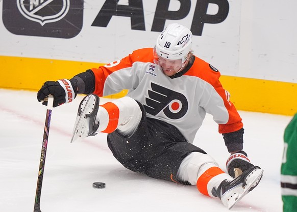 Philadelphia Flyers center Rodrigo Abols (18) reaches for the puck against Dallas Stars defenseman Ilya Lyubushkin (46) during the first period of an NHL hockey game Saturday, Nov. 15, 2025, in Dallas ...