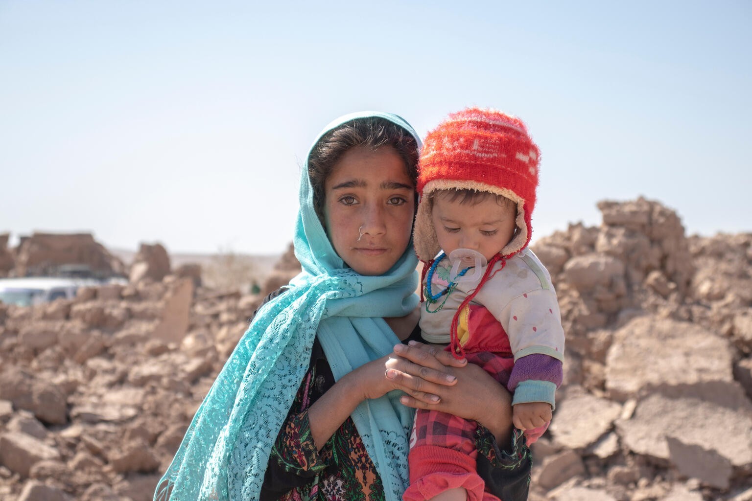 On 10 October 2023, 10-year-old Zari holds her brother, Marv, 8 months old, after they lost their home to the earthquake in Zinda Jan district, Afghanistan. 

A view of one village in Zinda Jan distri ...