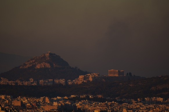 A general view of the of Athens with the Acropolis hill as fire burns the northern part of the city on Monday, Aug. 12, 2024, while hundreds of firefighters tackle a major wildfire raging out of contr ...