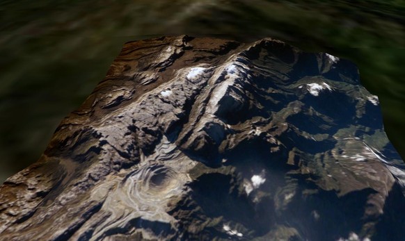 Satellitenaufnahme des Puncak Jaya (Mitte 2005), links vorne die Kupfermine und Gletscherreste oben rechts. Der Gipfel befindet sich oben am äussersten Punkt der zentralen Rippe.