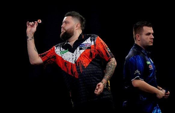 England's Michael Smith, left, competes against Netherland's Niels Zonneveld on day ten of the Paddy Power World Darts Championship in London, England, Saturday, Dec. 20, 2025. (Bradley Coll ...
