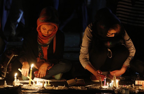 epa05438536 Afgans light candles during a memorial for the victims of a suicide bomb blast, in Kabul, Afghanistan, 23 July 2016. According to reports, at least 80 people were killed and more than 550  ...