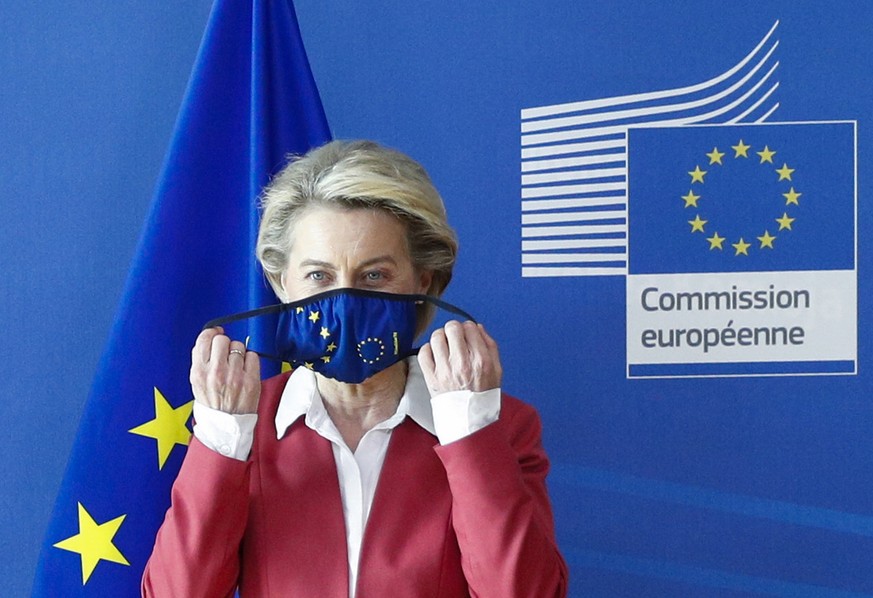 European Commission President Ursula von der Leyen puts on her protective face mask prior to a meeting with Dutch Prime Minister Mark Rutte at EU headquarters in Brussels, Wednesday, June 2, 2021. (Jo ...