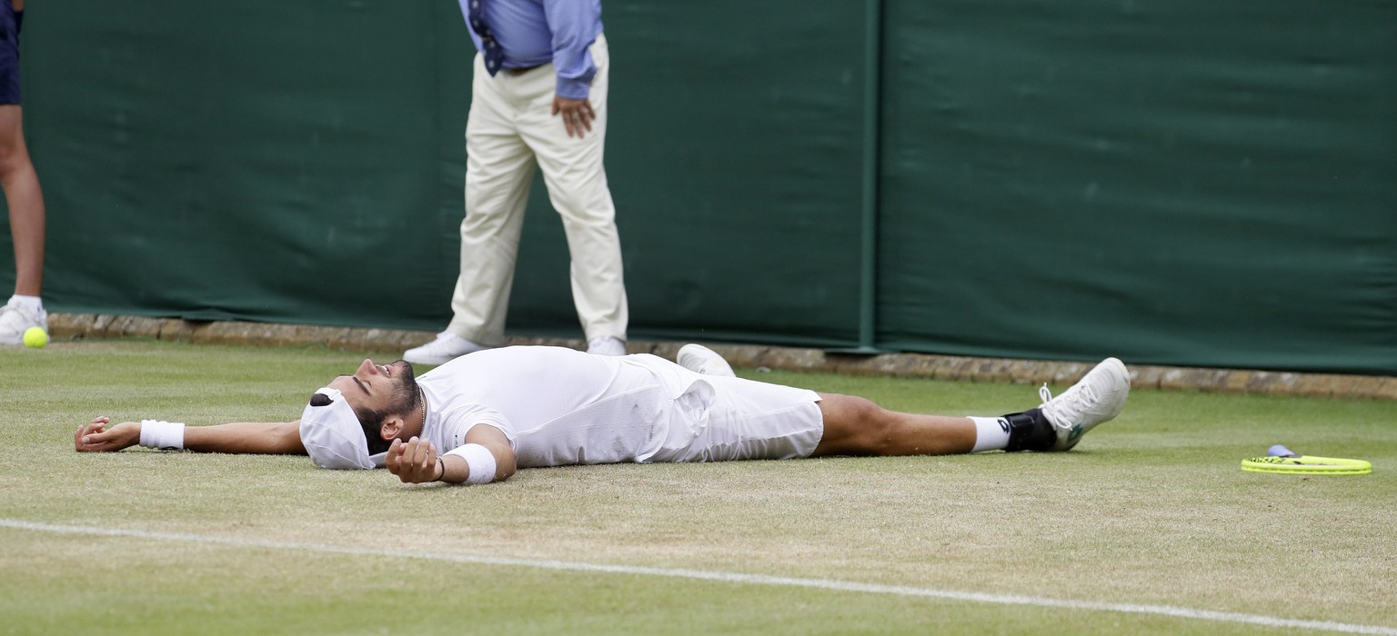 Italy&#039;s Matteo Berrettini falls to the ground as he celebrates after beating Argentina&#039;s Diego Schwartzman in a Men&#039;s singles match during day six of the Wimbledon Tennis Championships  ...