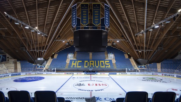 epa09656467 A covered TV camera stands among empty stands at the ice stadium in Davos, Switzerland, 25 December 2021. The 94th Spengler Cup was canceled one day before the start of the traditional tou ...