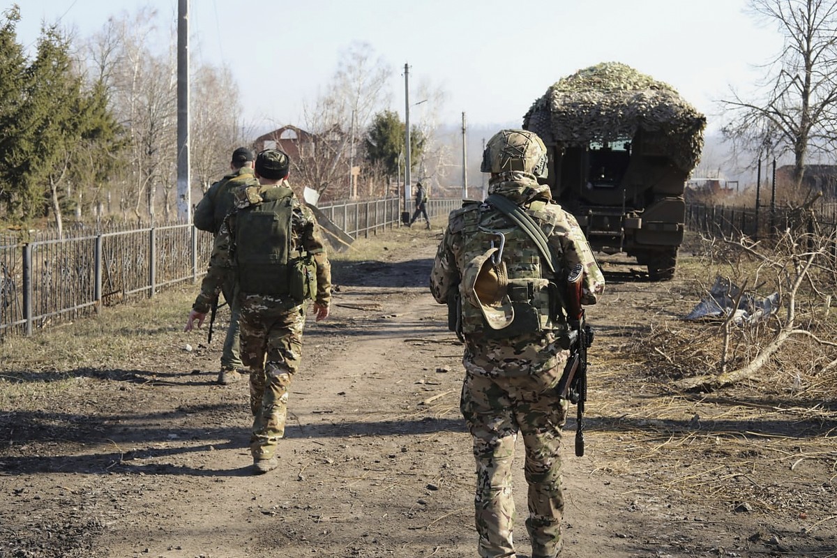In this photo taken from video distributed by Russian Defense Ministry Press Service on Friday, March 14, 2025, Russian soldiers patrol an area in the Kursk region of Russia after it was taken over by ...