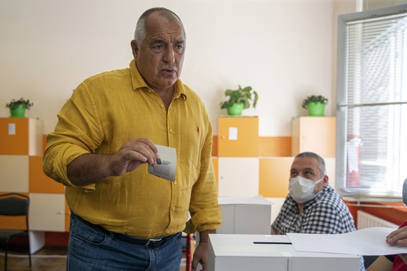 Bulgarian former prime minister Boyko Borissov casts his vote during parliamentary elections in the town of Bankya near capital Sofia, Bulgaria on Sunday, July 11, 2021. Bulgarians are voting in a sna ...