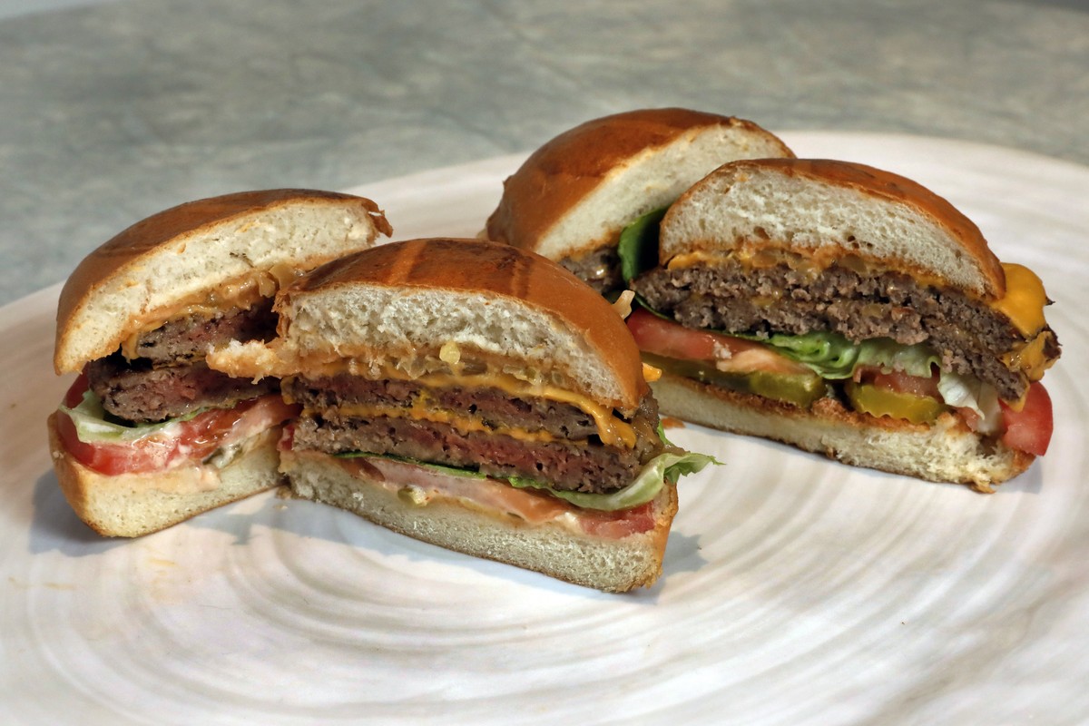 FILE - This Friday, May 3, 2019 file photo shows an Original Impossible Burger, left, and a Cali Burger, from Umami Burger, in New York. A new era of meat alternatives is here, with Beyond Meat becomi ...