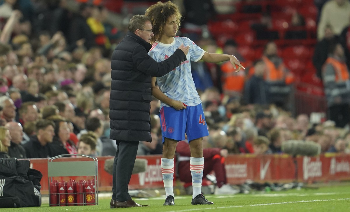 Manchester United's interim manager Ralf Rangnick speaks with his player Hannibal Mejbri during the English Premier League soccer match between Liverpool and Manchester United at Anfield stadium  ...