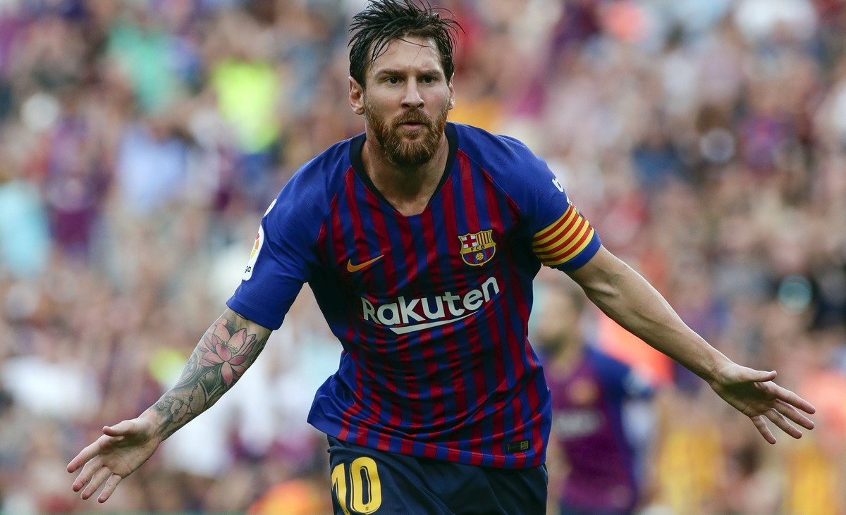 Barcelona's Lionel Messi celebrates scoring the opening goal during a Spanish La Liga soccer match between Barcelona and Huesca at the Camp Nou stadium in Barcelona, Spain, Sunday Sept. 2, 2018.  ...