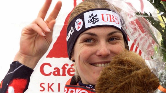 Karin Roten of Switzerland shows the victory sign to fans on the podium after winning the women&#039;s ski world cup slalom in Veysonnaz, Switzerland, December 20, 1998. Roten won the race with a time ...