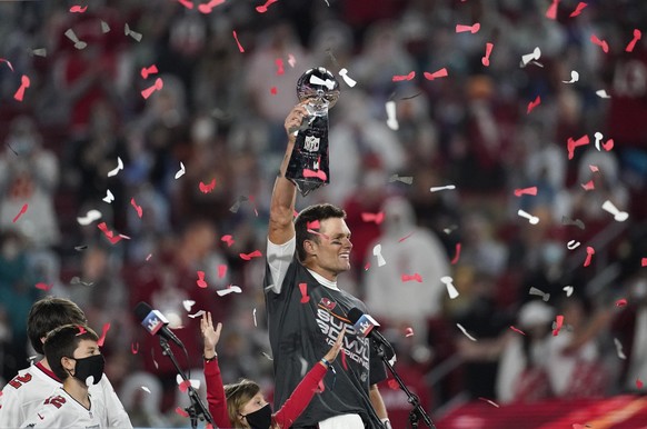 FILE - Tampa Bay Buccaneers quarterback Tom Brady holds up the Vince Lombardi trophy after defeating the Kansas City Chiefs in the NFL Super Bowl 55 football game, Feb. 7, 2021, in Tampa, Fla. Brady,  ...