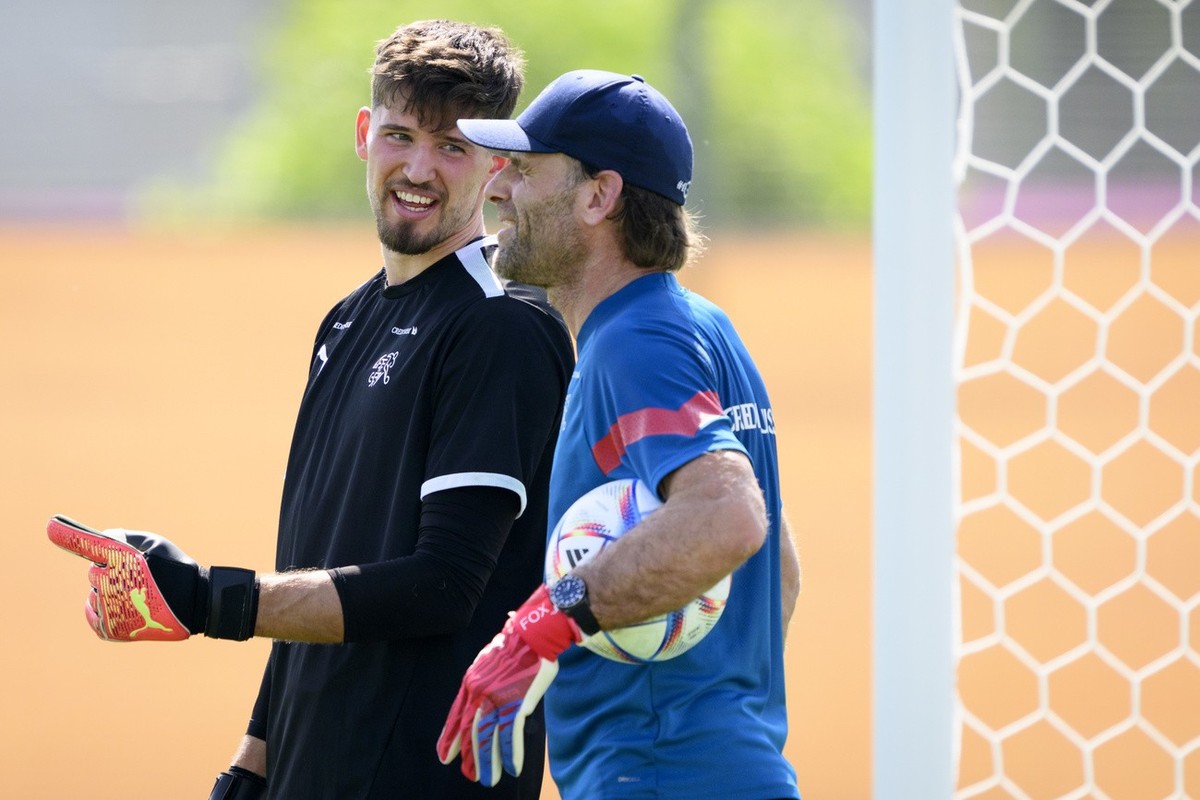 Switzerland's goalkeeper Gregor Kobel, left, speaks with Switzerland's goalkeeper coach Patrick Foletti, right, during a open training session of Swiss national soccer team in preparation fo ...